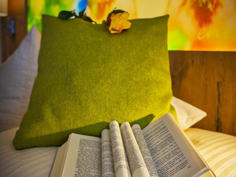 Entspannung für Leseratten mit Buch auf dem Bett im Hotel Sonnengarten Bad Wörishofen